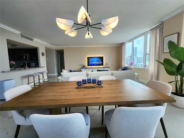 a bedroom with a bed wooden floor and a large window