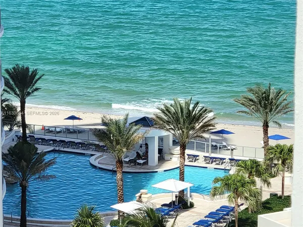 a view of a house with pool porch and sitting area