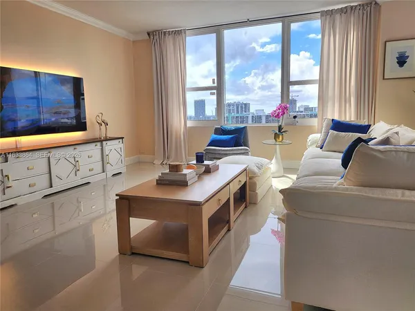 a living room with furniture and a flat screen tv