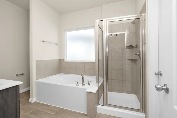 a bathroom with a tub a sink and a mirror