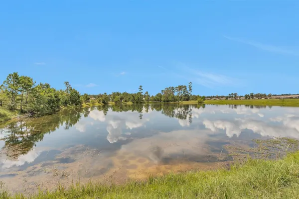 a view of a lake with a house in the background