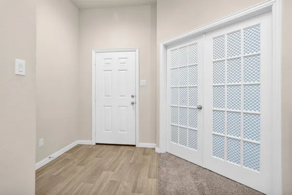 a view of an empty room with a window