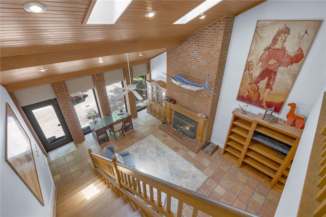 218 Northridge Drive Anderson, SC 29621 - Photo 13 of 50 A striking brick fireplace anchors this open living space, crowned by soaring wood-beamed ceilings and skylights.