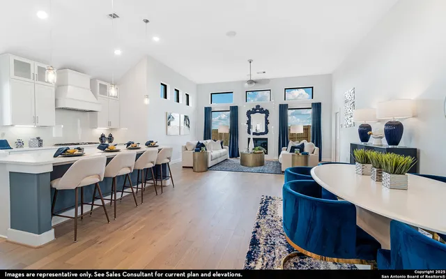 a living room with furniture a chandelier and a dining table