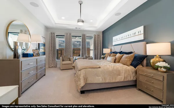 a spacious bedroom with a bed and a chandelier