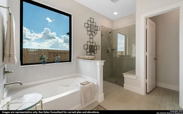 a bathroom with a tub a toilet and a shower