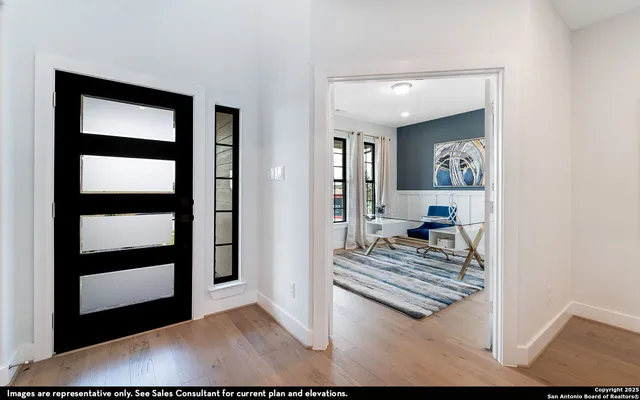 a view of a livingroom with wooden floor and furniture