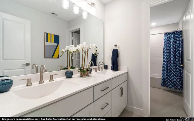 a bathroom with a double vanity sink mirror and