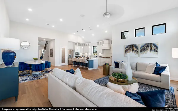 a living room with furniture and kitchen view