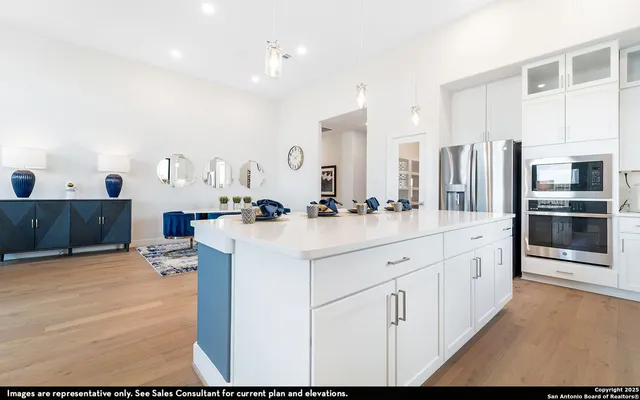 a large white kitchen with stainless steel appliances