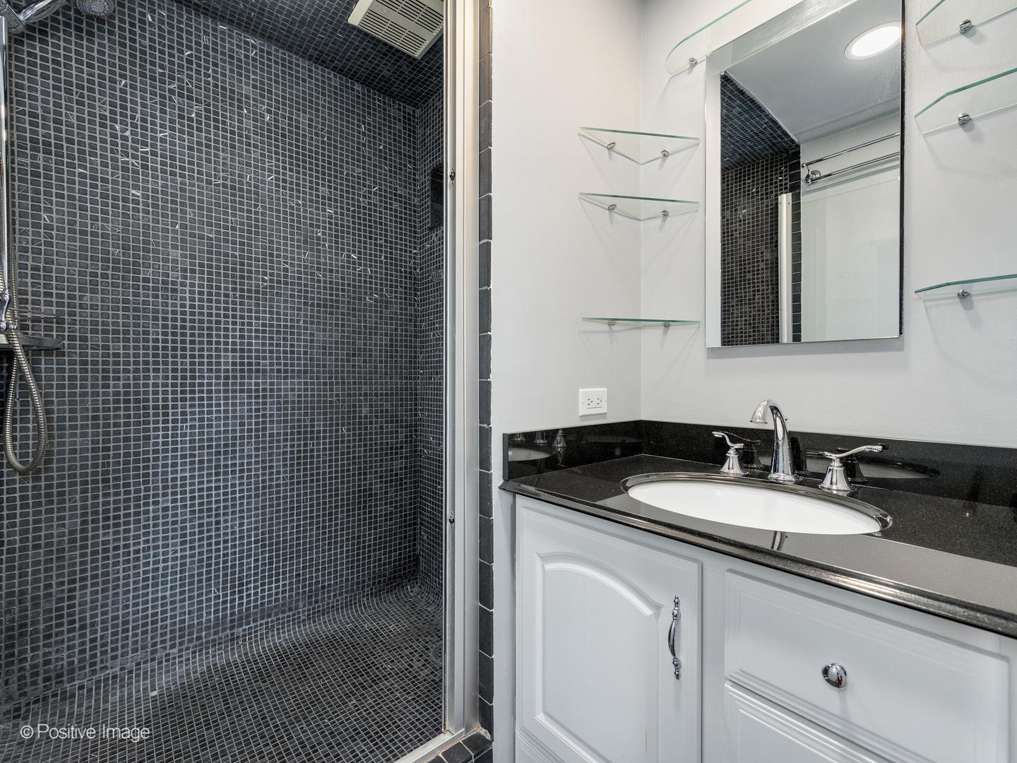 300 North State Street, Unit 5317 Chicago, IL 60654 - Photo 13 of 27 a bathroom with a granite countertop sink a mirror and vanity