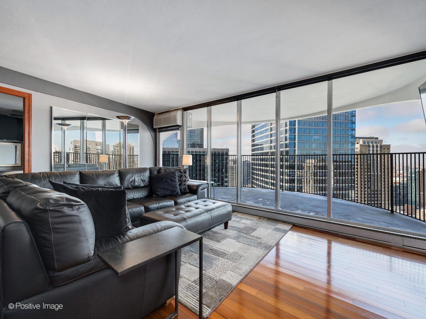 300 North State Street, Unit 5317 Chicago, IL 60654 - Photo 2 of 27 a living room with furniture and a floor to ceiling window
