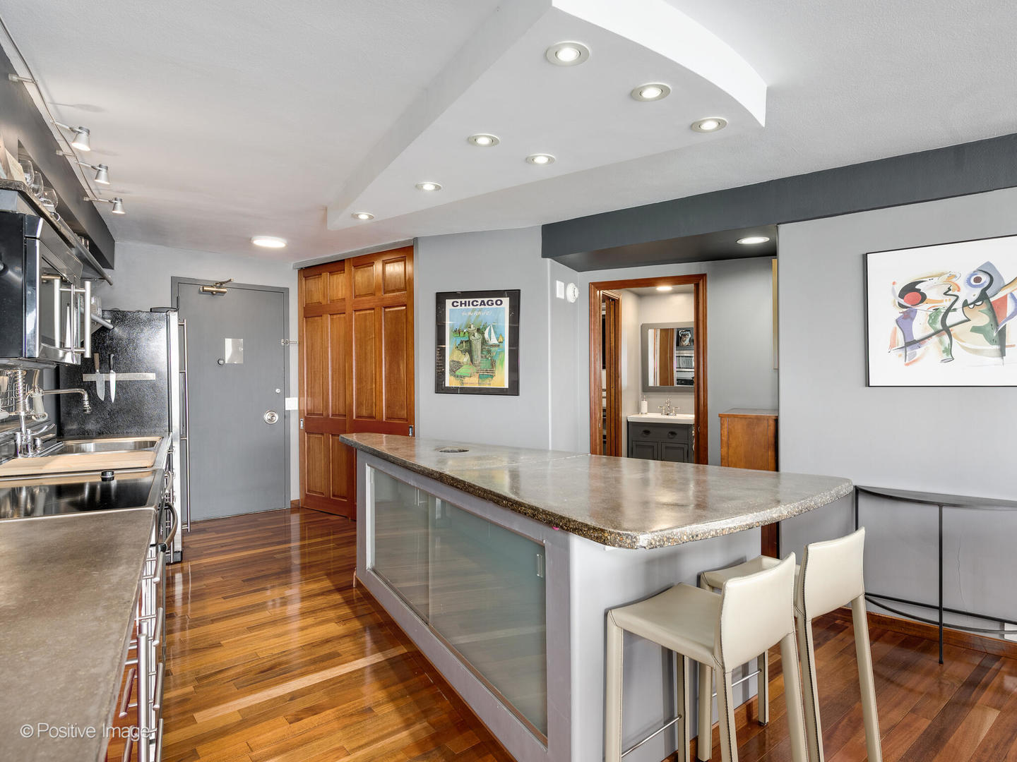 300 North State Street, Unit 5317 Chicago, IL 60654 - Photo 6 of 27 a large kitchen with stainless steel appliances granite countertop a large counter top and a stove