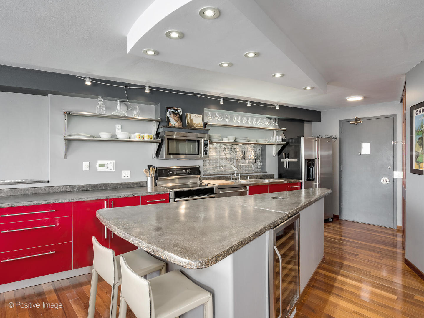 300 North State Street, Unit 5317 Chicago, IL 60654 - Photo 7 of 27 a kitchen with stainless steel appliances granite countertop a kitchen island a stove and a wooden cabinets
