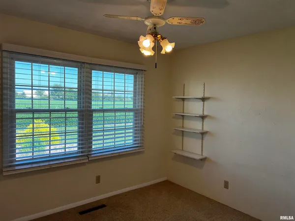 a view of a livingroom with a large window and chandelier