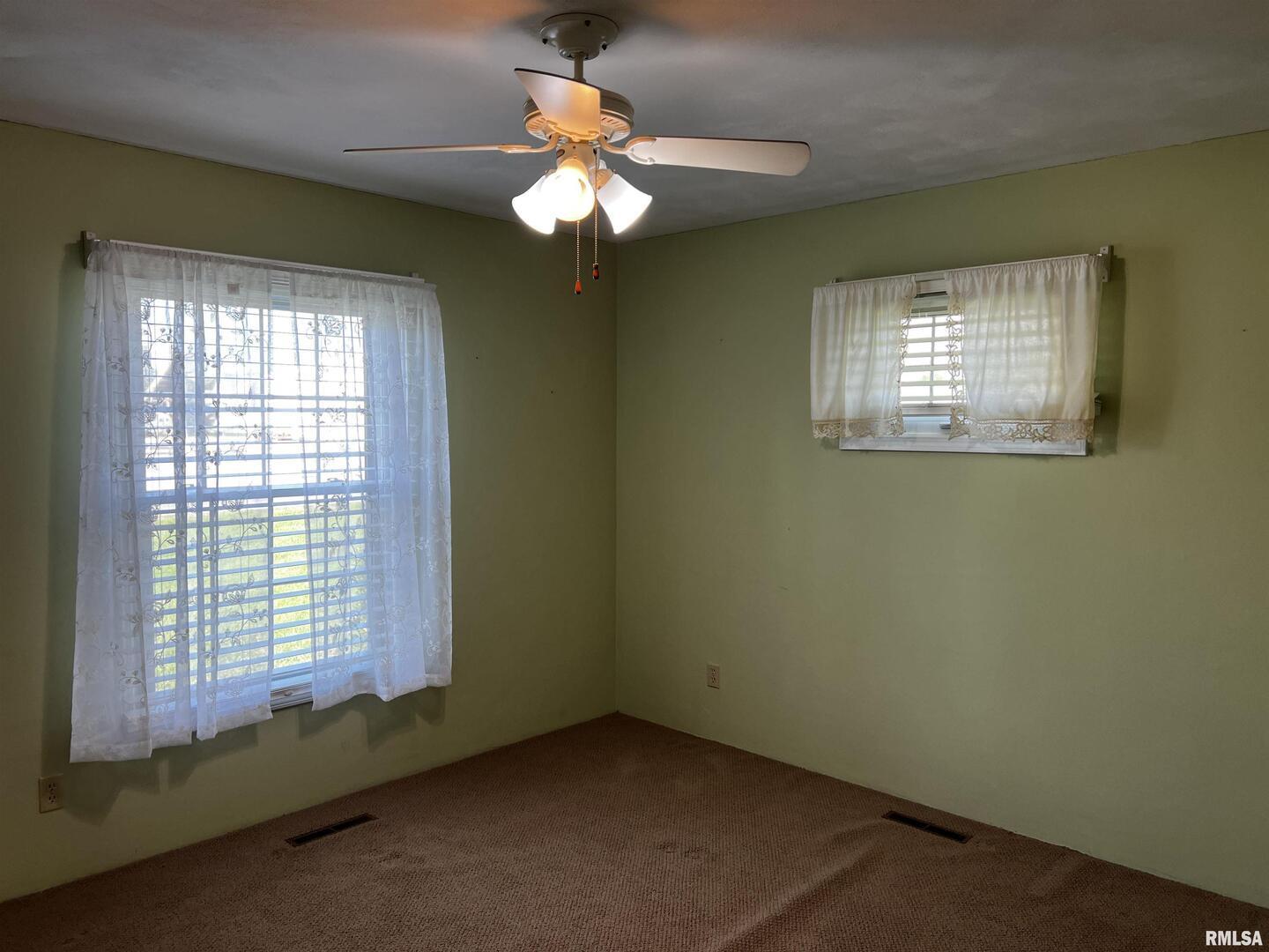 210 West Fifth Street St. Peter, IL 62880 - Photo 16 of 48 a view of a livingroom with a chandelier fan and a window