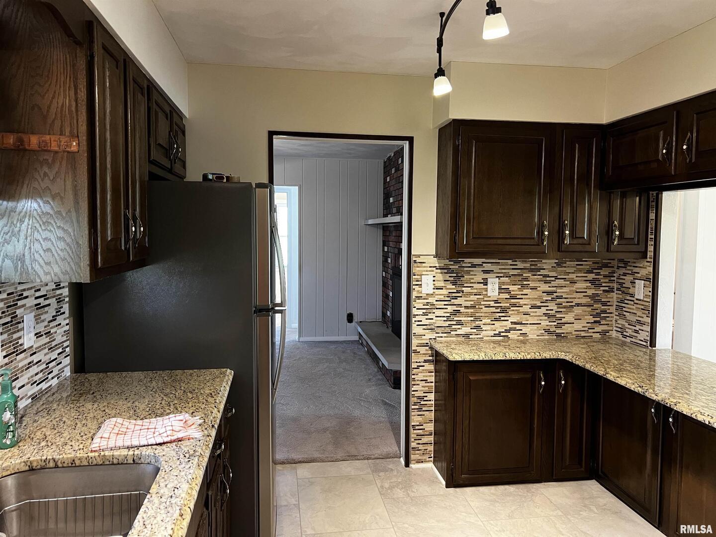 210 West Fifth Street St. Peter, IL 62880 - Photo 20 of 48 a kitchen with granite countertop a refrigerator and a stove