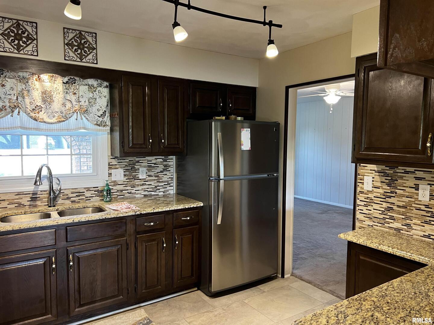 210 West Fifth Street St. Peter, IL 62880 - Photo 22 of 48 a kitchen with stainless steel appliances granite countertop a refrigerator and a sink