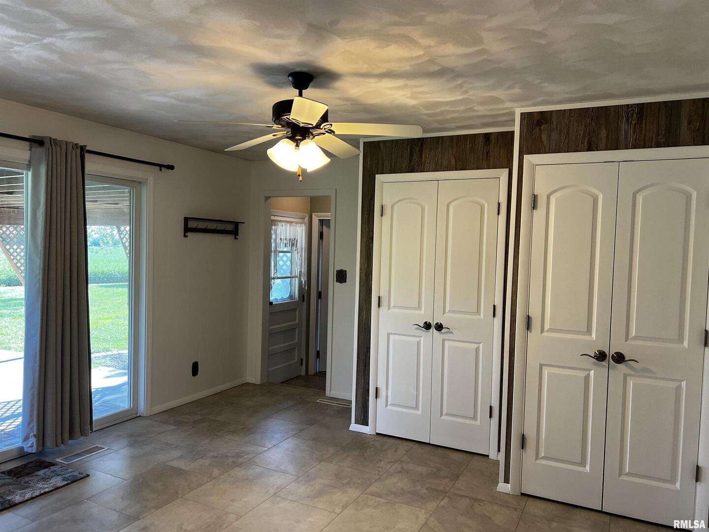 210 West Fifth Street St. Peter, IL 62880 - Photo 26 of 48 an empty room with windows and a chandelier fan