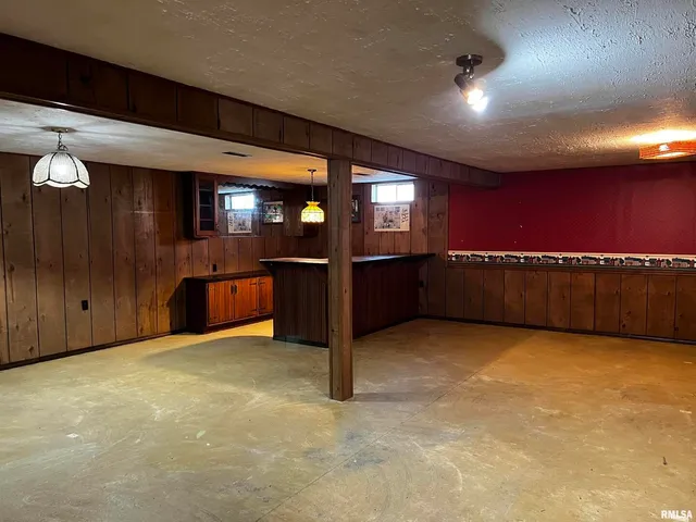 a view of an empty room with kitchen