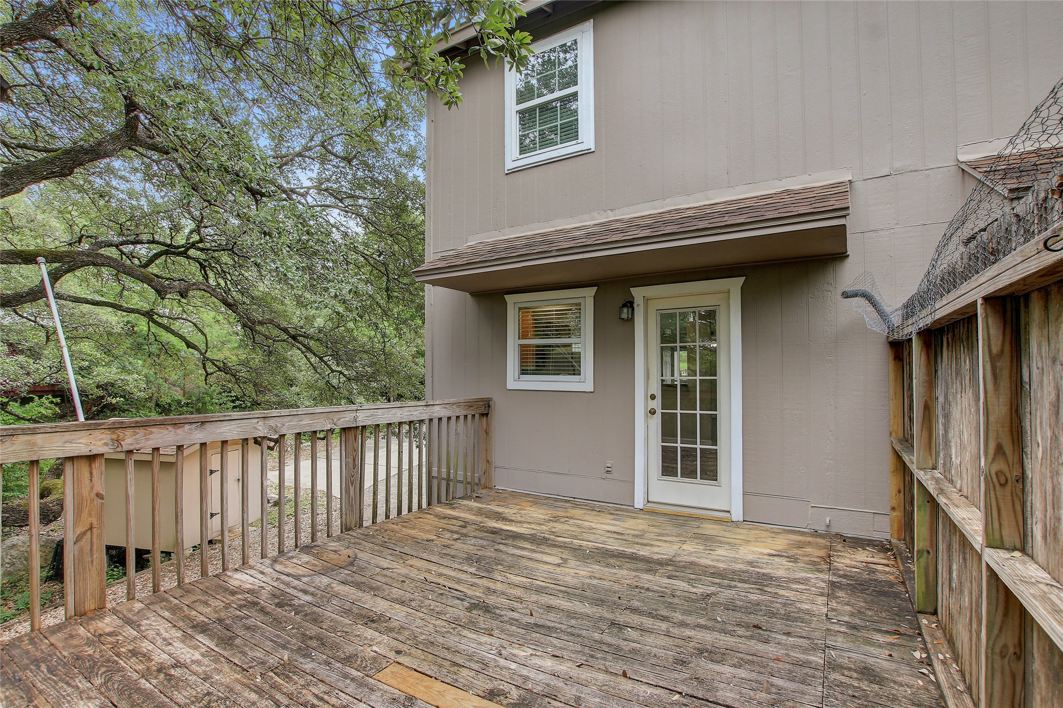 6902 Rifle Bend, Unit B Austin, TX 78736 - Photo 32 of 34 a house with trees in front of it