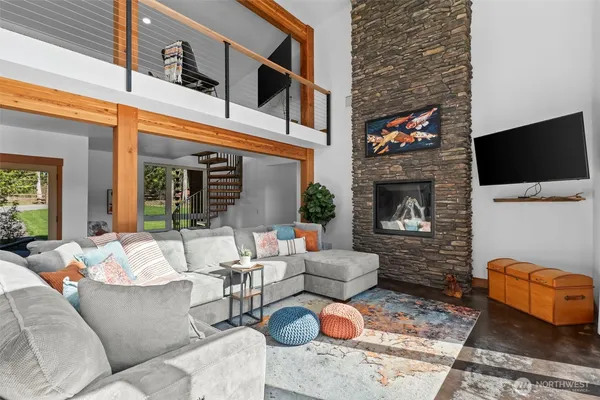 a living room with furniture a flat screen tv and a fireplace