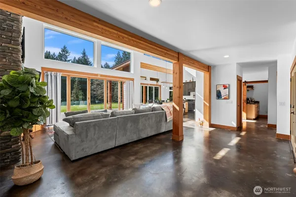 a living room with furniture and large windows