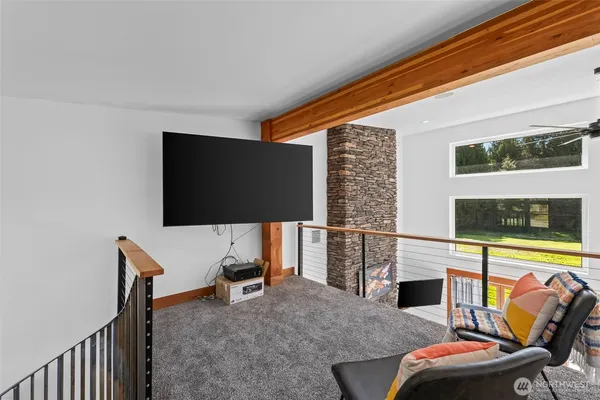 a living room with furniture and a floor to ceiling window