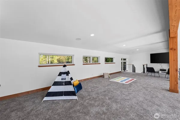 a living room with kitchen island furniture and a flat screen tv