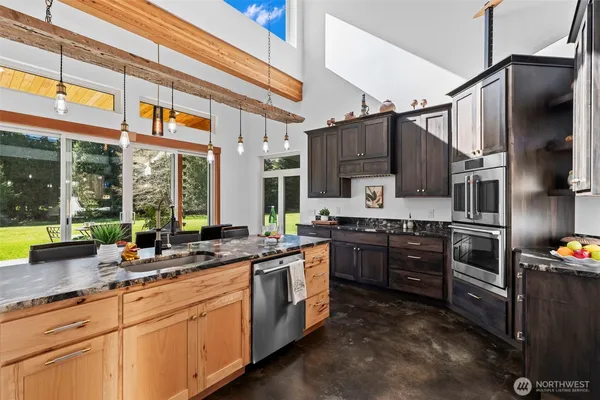 a kitchen with stainless steel appliances granite countertop a stove and a refrigerator