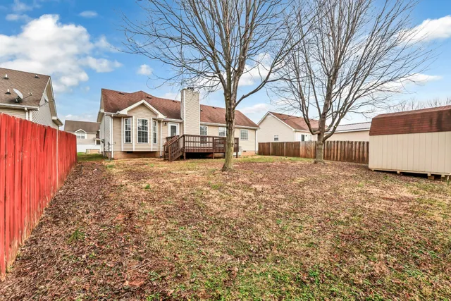 a view of a house with a yard covered in snow