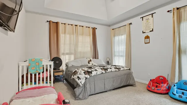 a bedroom with a bed and a window