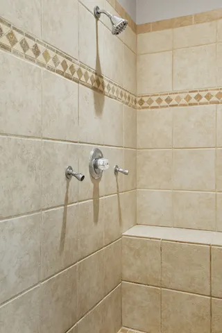a utility room with dryer and baby crib