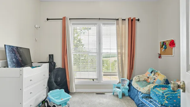 a bedroom with furniture and a window