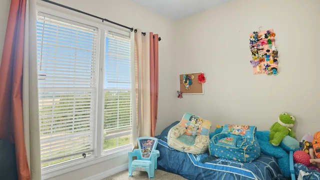 a living room with furniture a flat screen tv and gym equipment
