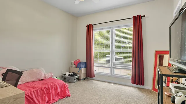 a living room with furniture and a lamp