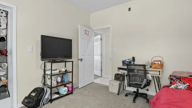 a bedroom with a bed and a chandelier