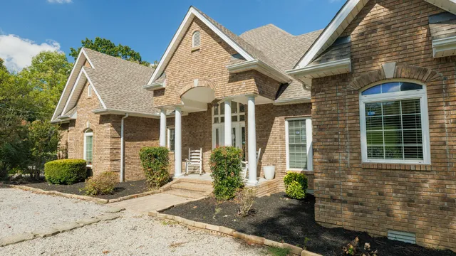 a view of a brick house with many windows