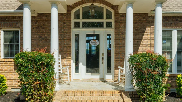 a backyard of a house with lots of green space and wooden fence