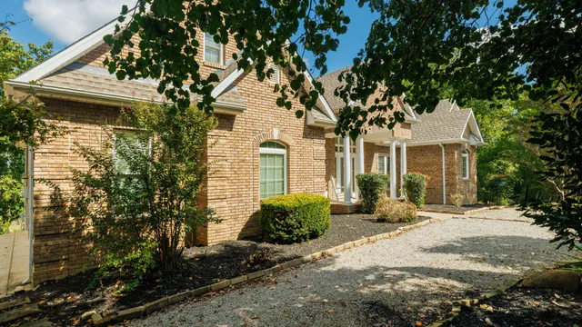 a view of a backyard with wooden fence