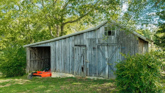 a backyard of a house with table and chairs