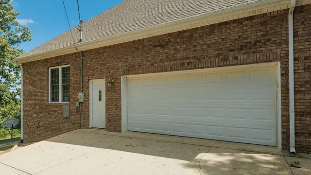 a backyard of a house with lots of green space and fountain