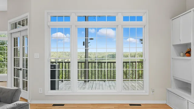 a living room with a fireplace and a book shelf