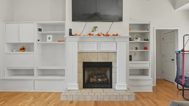 a view of a dining room with furniture a chandelier and wooden floor