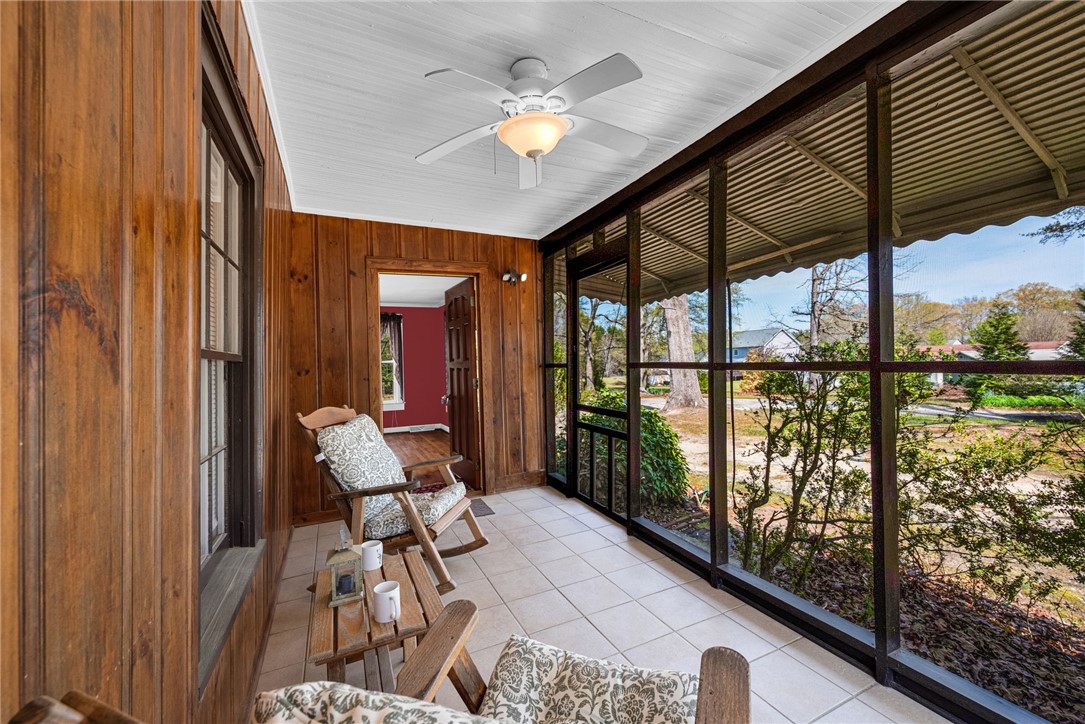245 Cromer Road Williamston, SC 29697 - Photo 3 of 27 Enjoy tranquil moments on this inviting screened porch, offering seamless indoor-outdoor living.