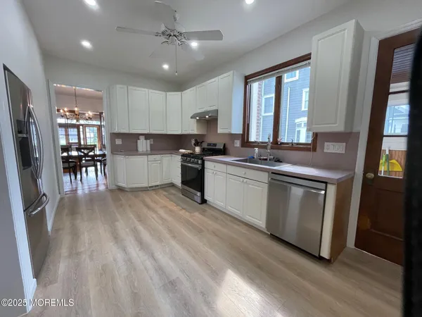a kitchen with a sink stove and cabinets