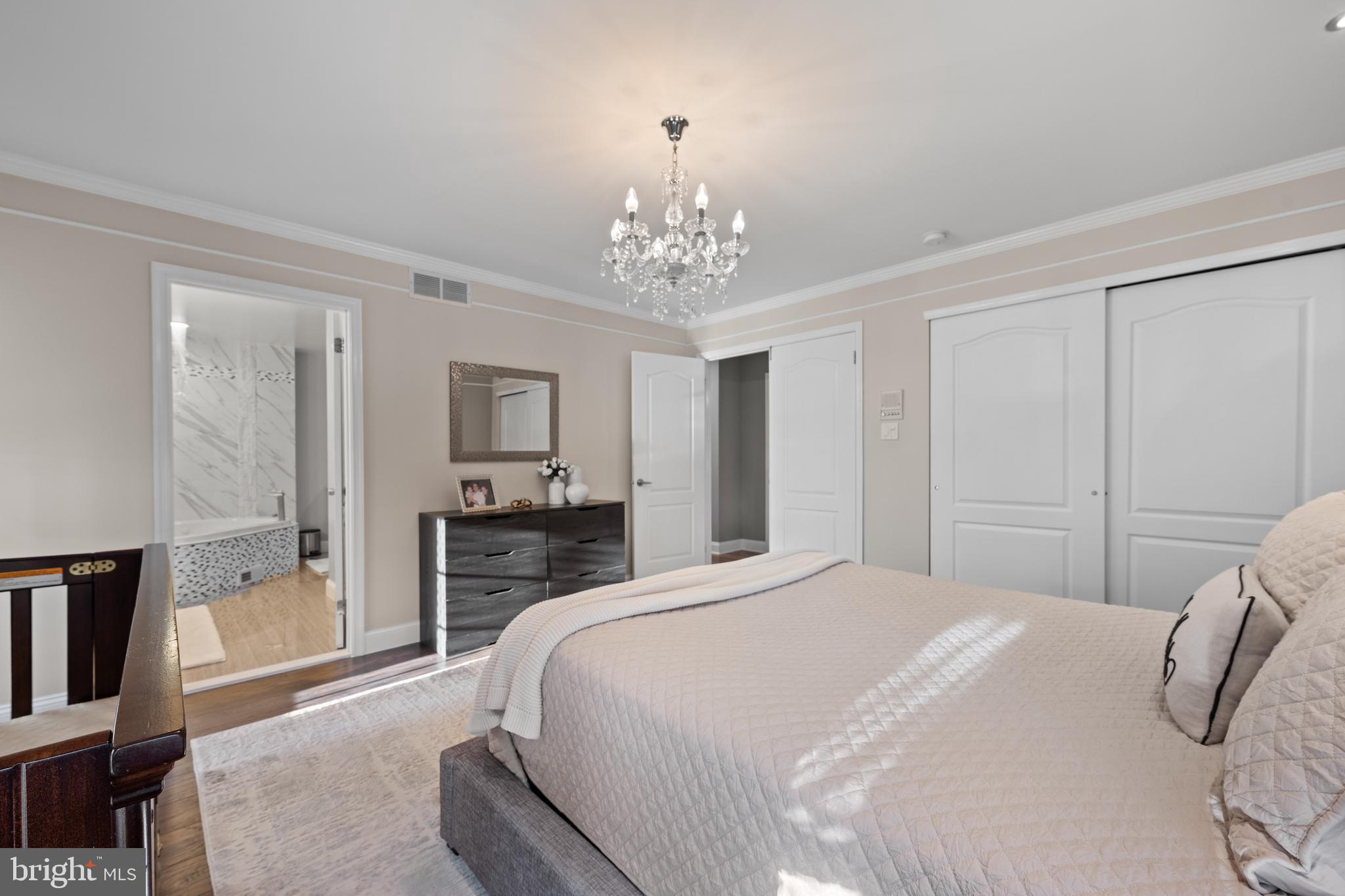 11 Frederick Street Sicklerville, NJ 08081 - Photo 25 of 57 a bedroom with a large bed and a chandelier