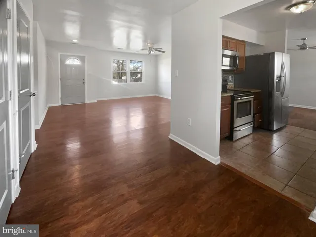 a view of a kitchen with a sink and a refrigerator