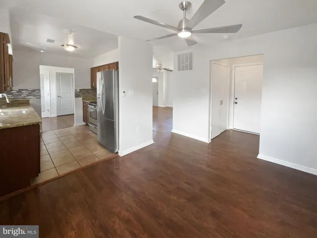 a view of a kitchen cabinets and wooden floor