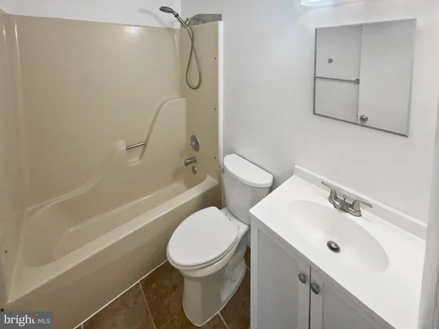 a bathroom with a toilet sink and shower